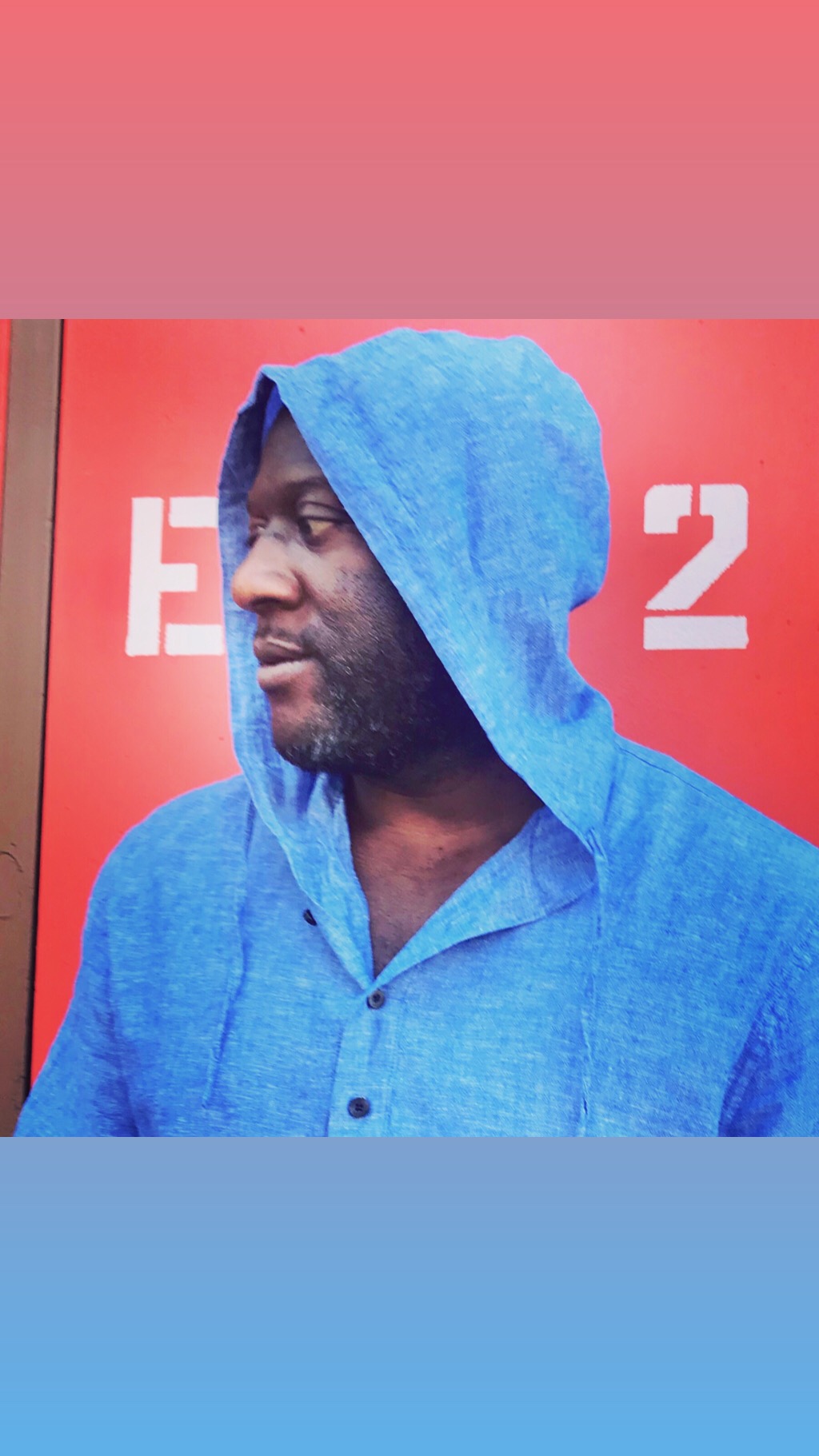 Tomike Ogugua in a blue hooded shirt
