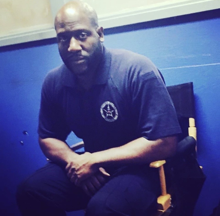 Tomike Ogugua behind the scenes in U.S. Marshal Macedon wardrobe